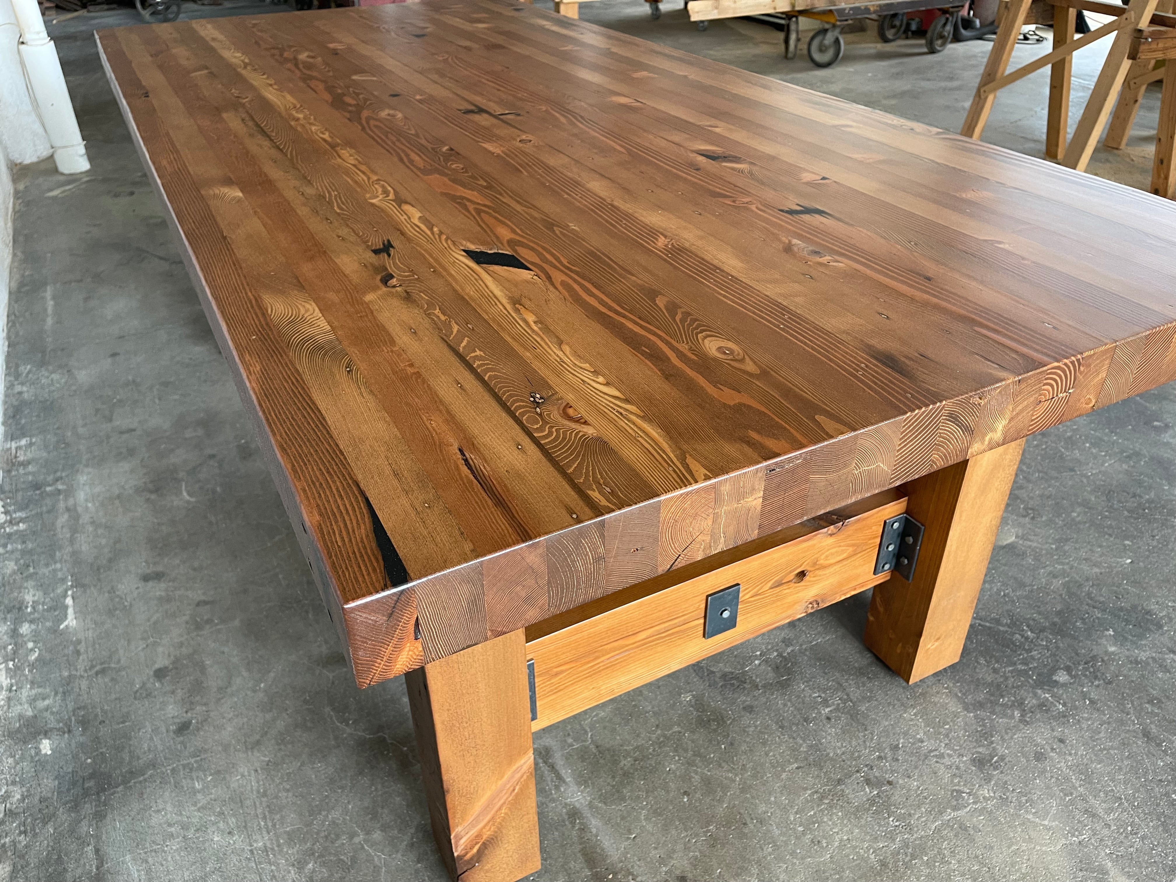 Ambassador farmhouse dining table - made from sustainalby-sourced reclaimed wood - shown in a walnut stain finish - the perfect table for dining rooms and kitchens