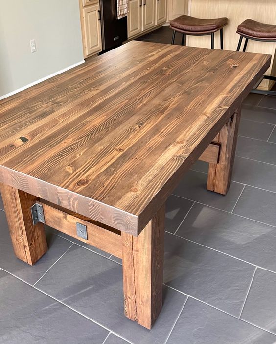 Ambassador Farmhouse Dining Table by Workshop Detroit - Shown in kitchen with two stools anf cabinets in background