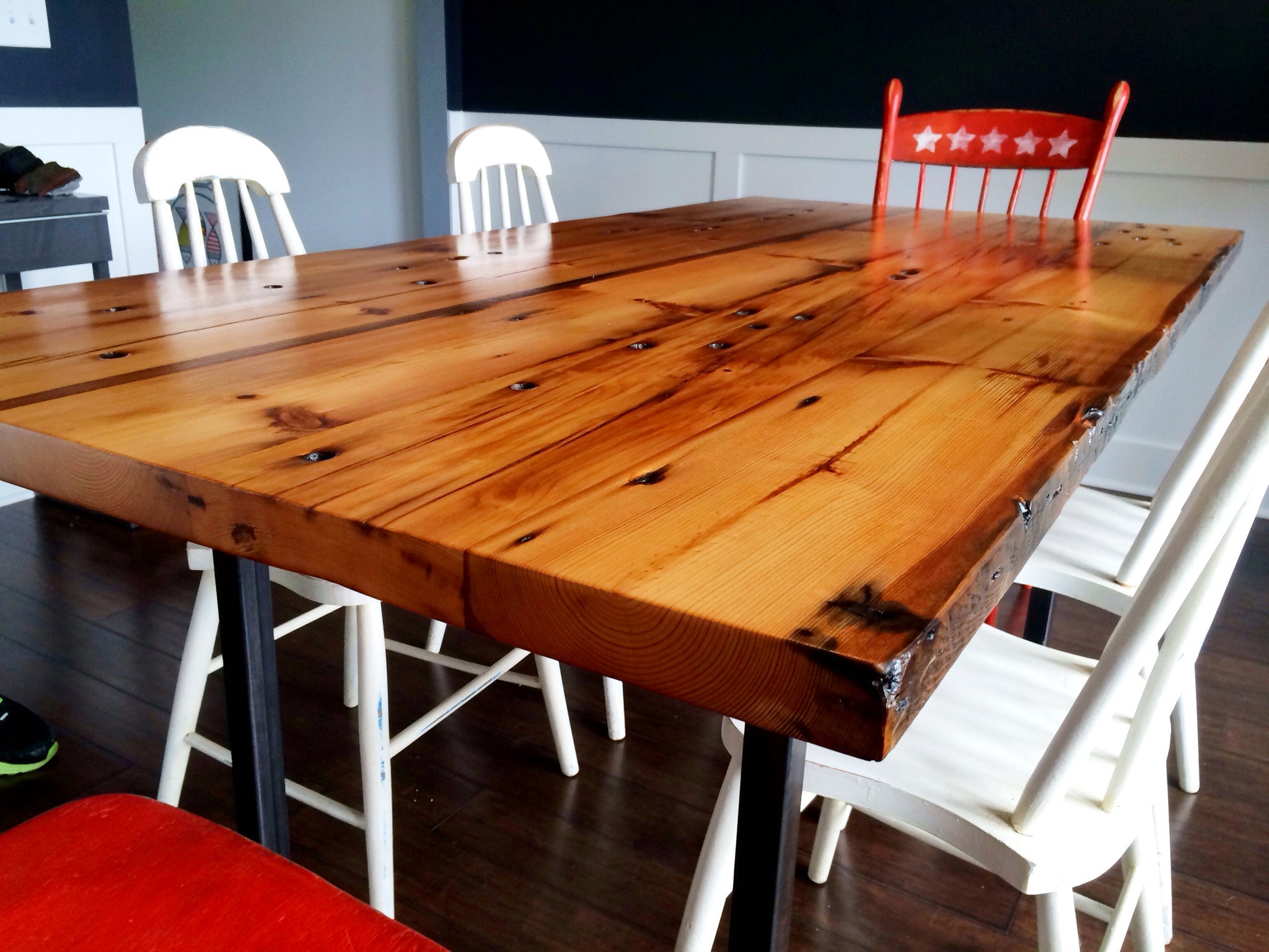 North End Dining Table by Workshop Detroit - Shown with white and red wooden chairs in a dining room 